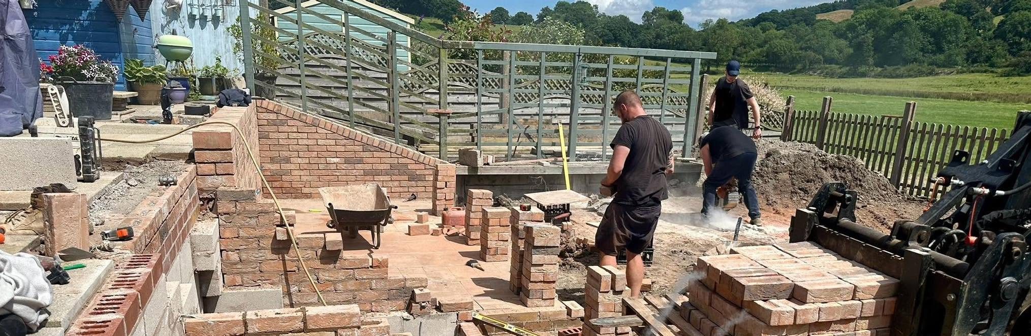 Experienced construction team carrying out brickwork and landscaping works