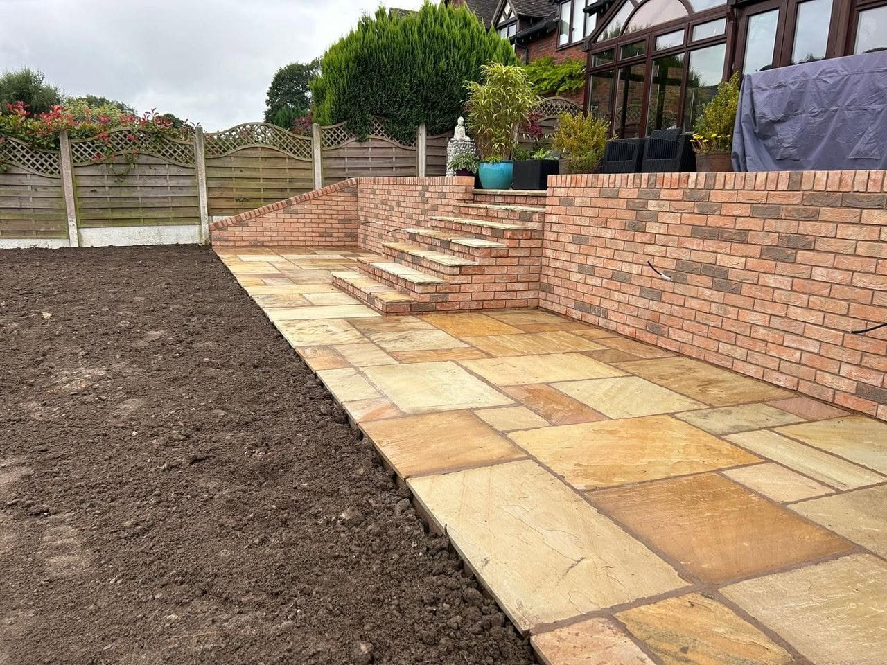 Completed brick retaining walls, steps and paved terrace